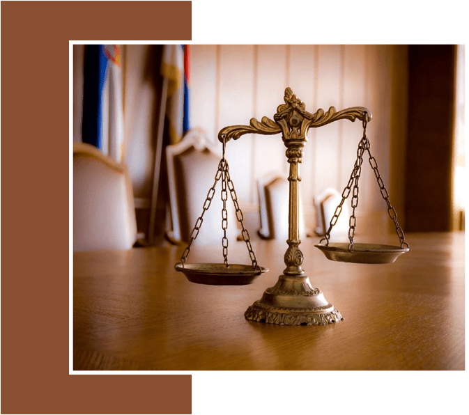 A close up of the scales of justice on top of a table.